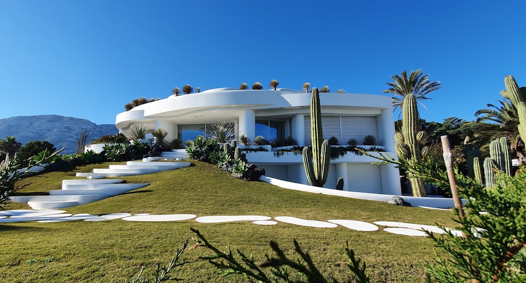 Luxury villa exterior with landscaped garden and private driveway