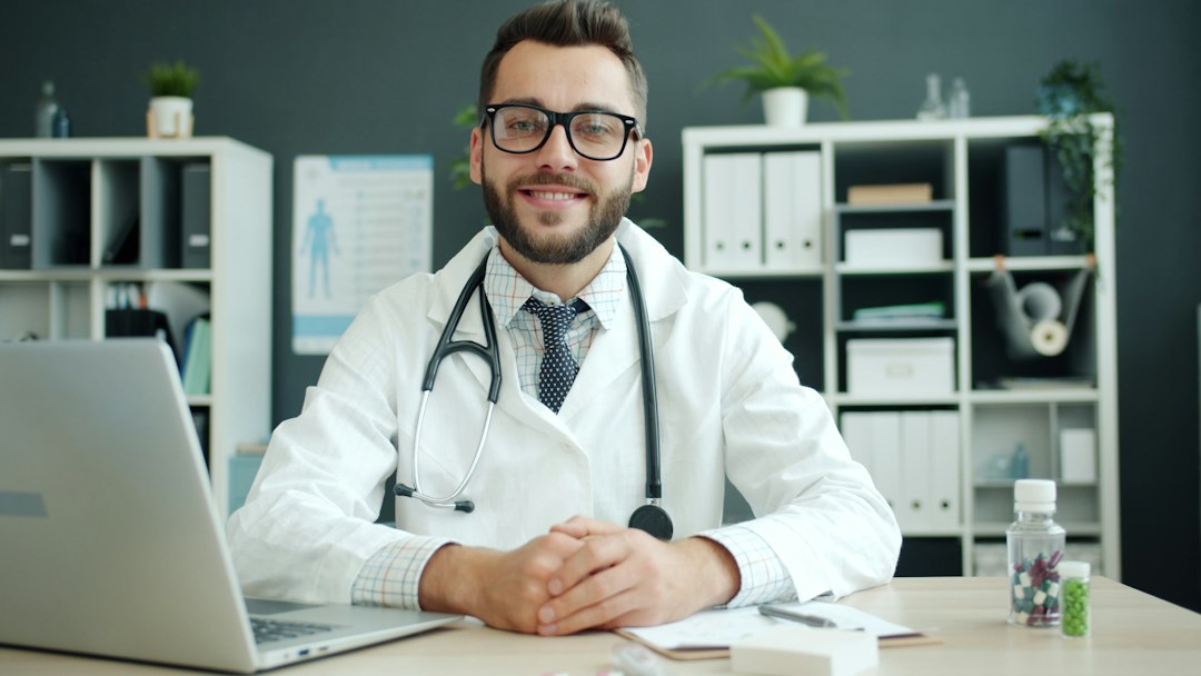 A homeopathic practitioner reviewing detailed patient case notes at a consultation desk, professional and focused