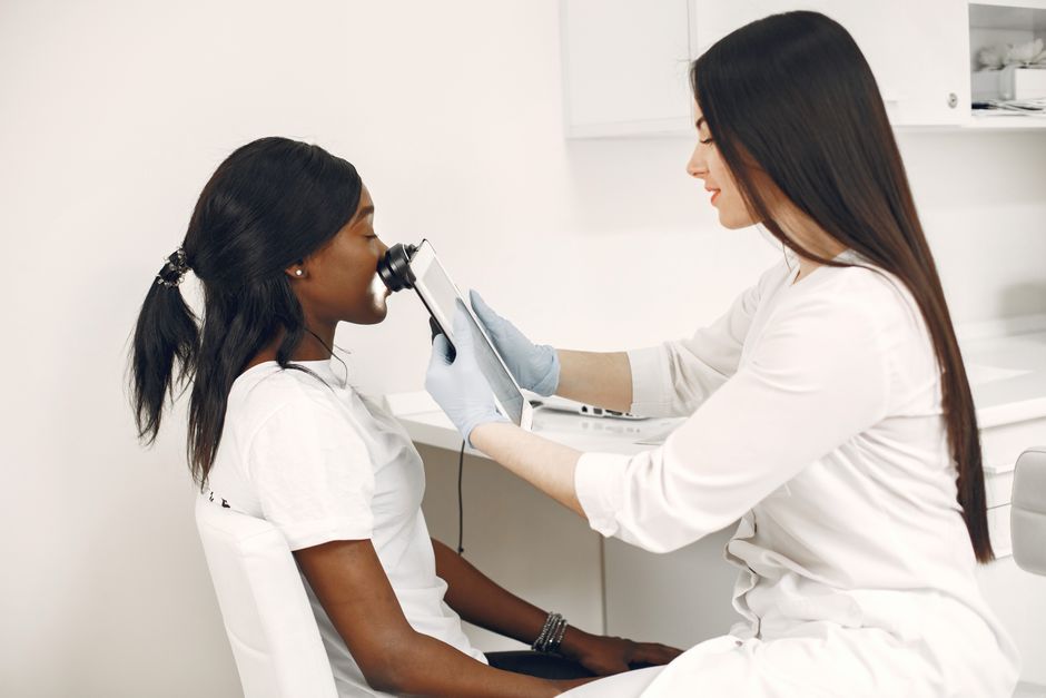Doctor reviewing a personalised skin treatment plan with a patient during a clinic consultation